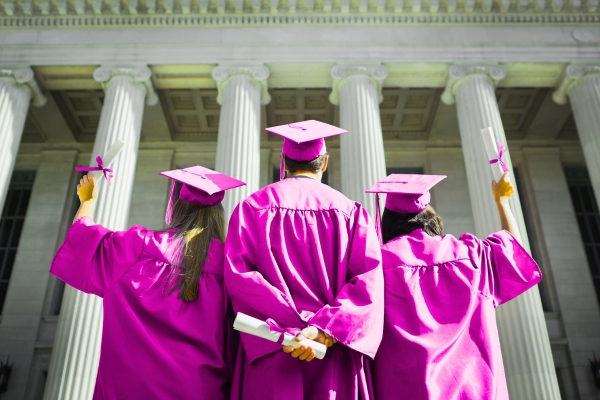 3 students in graduation caps and gowns