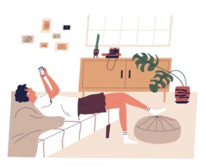 Man lying on couch browsing social media.