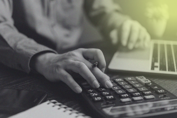 person typing on calculator