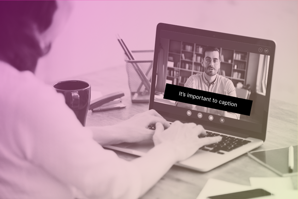 woman watching a video on her laptop with captions on screen