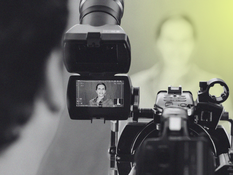 camera filming woman in news studio