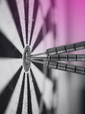 darts hitting a bullseye on a dartboard