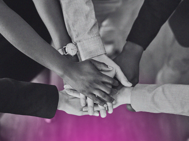 team putting their hands together in a circle