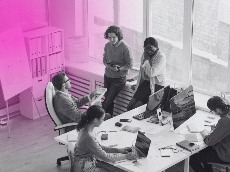 team having discussion around desk