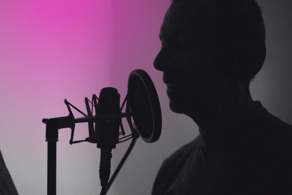 silhouette of a person speaking into a microphone
